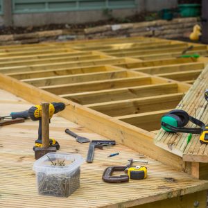 Image of tools, joists and planks, of a low level deck under construction